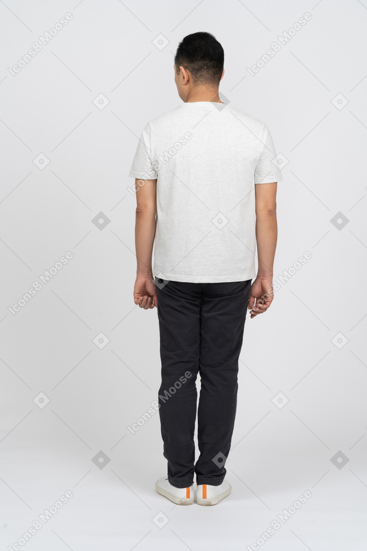 Back view of a man in casual clothes looking aside