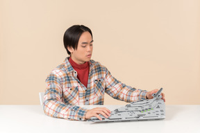 An asian geek guy in a checkered shirt