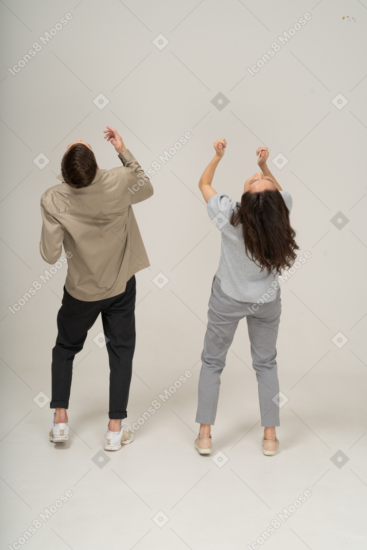 Young man and woman looking up