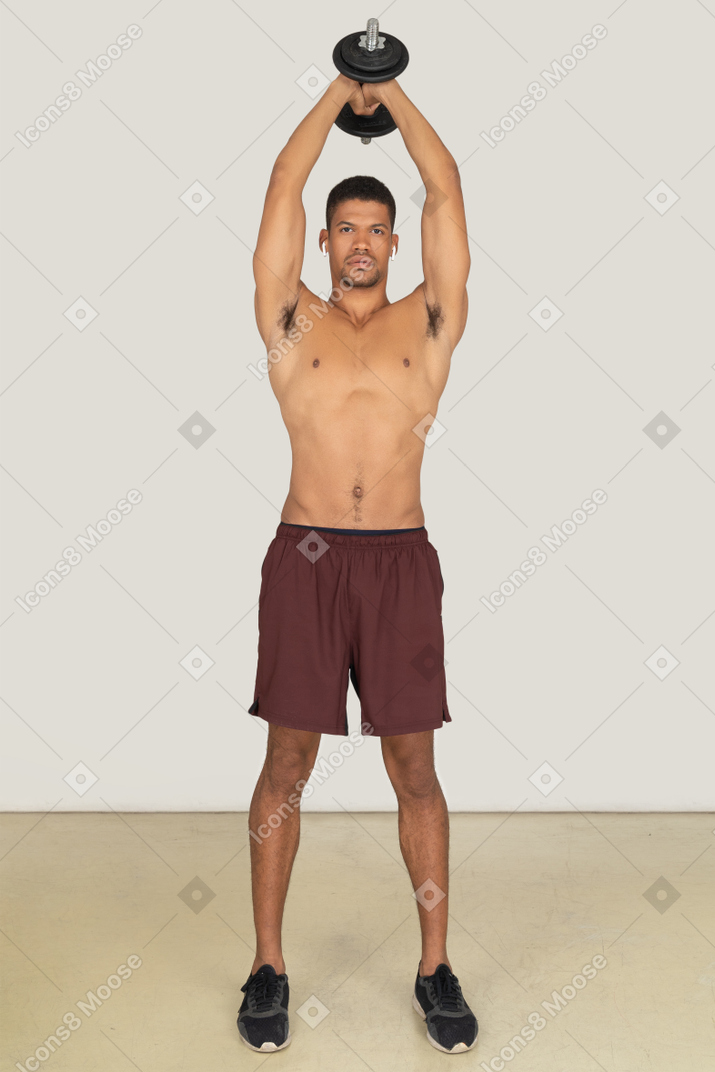 Athletic man doing exercises with dumbbell