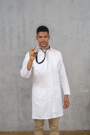 Male doctor using a stethoscope