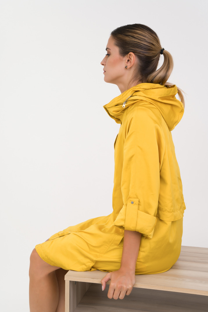 Young woman in a yellow rain jacket