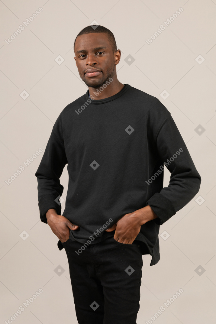 Young man posing with his hands in pockets