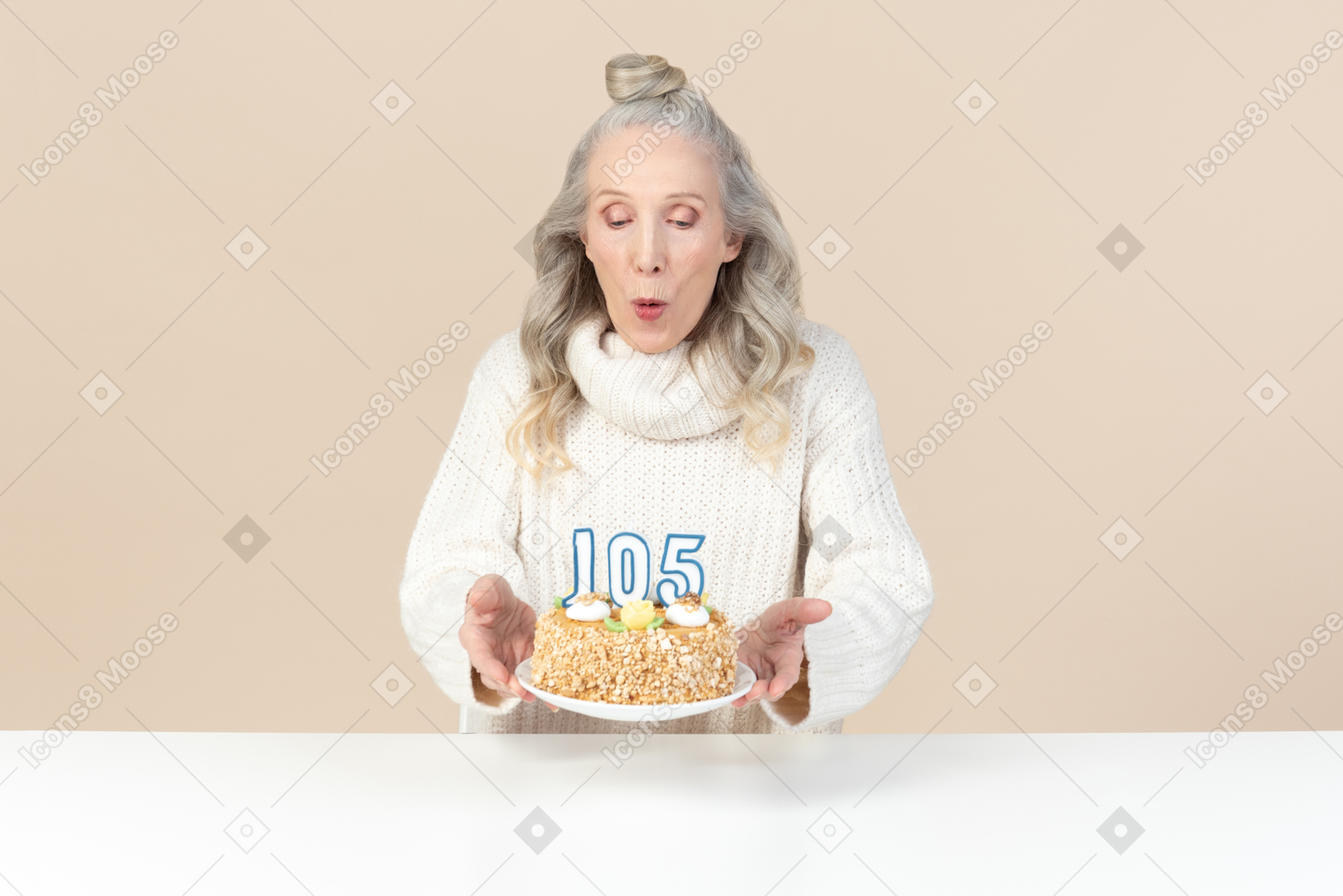 Old woman blowing out the candles on cake for her hundred and fifth birthday