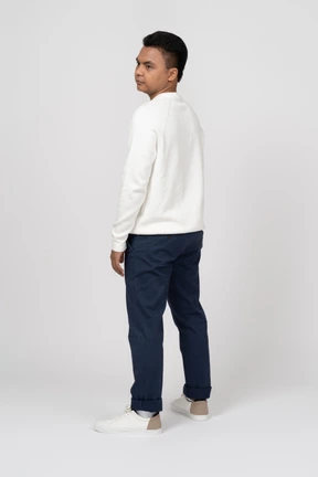 Man in a white pullover standing