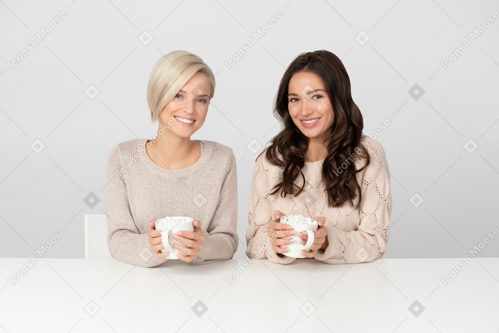 Young women smiling and drinking coffee