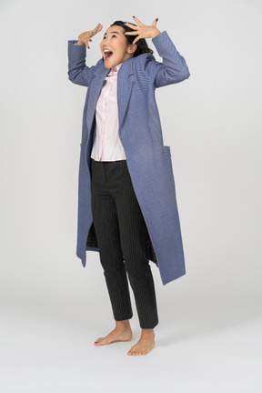 Excited woman in coat gesturing