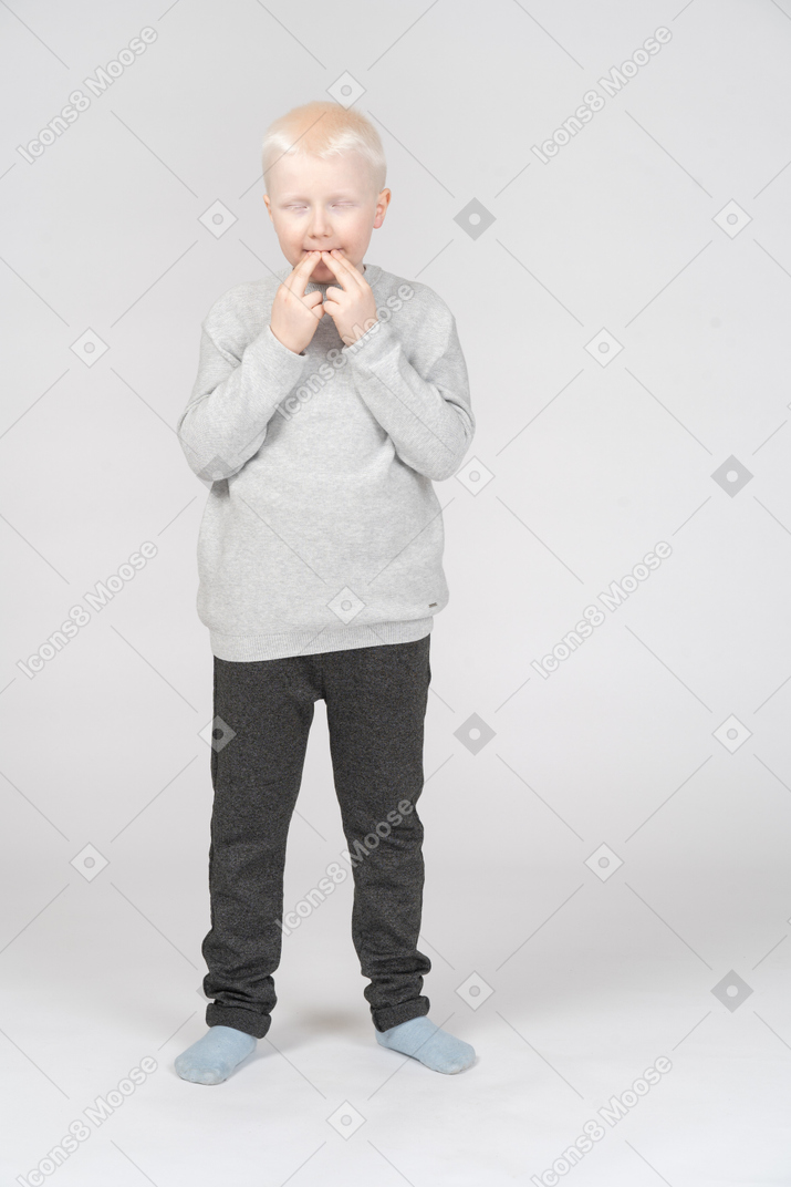 Little boy whistling with his fingers