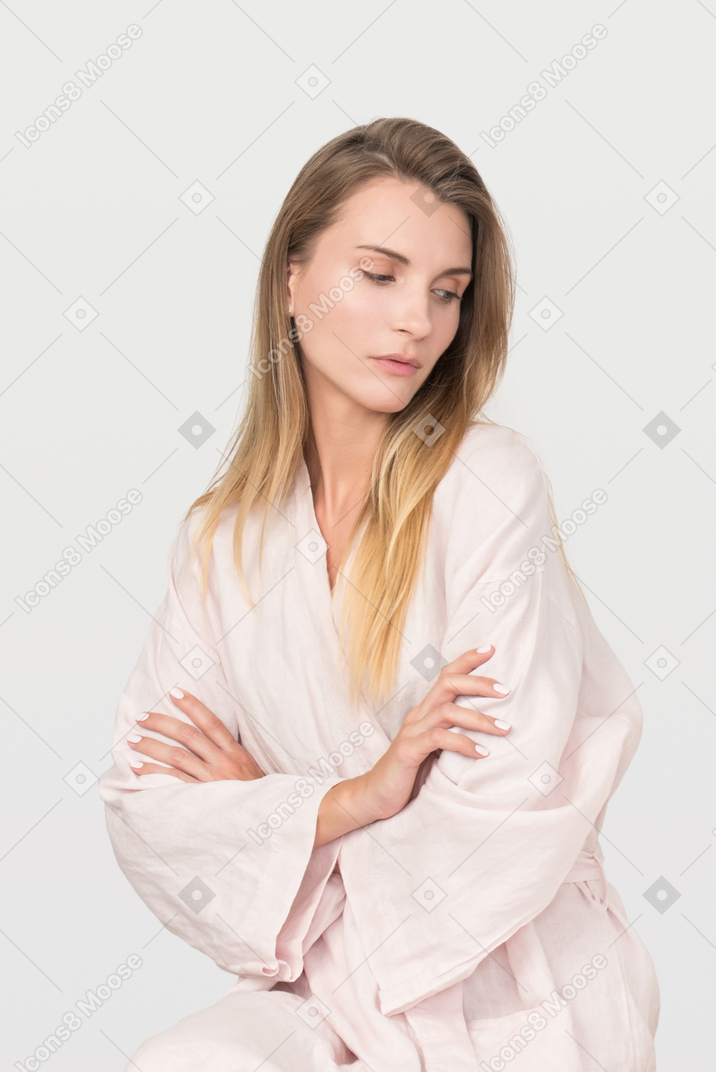 Beautiful young woman in a pink robe