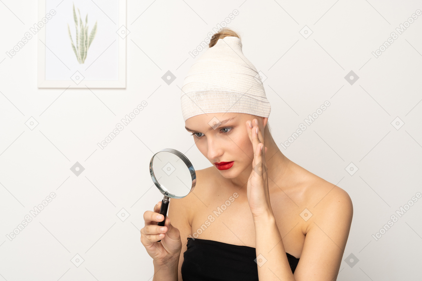 Young woman looking through magnifier and touching her cheek