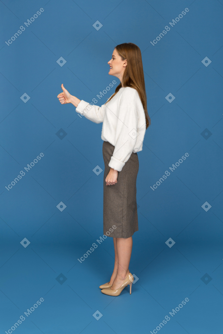 Young businesswoman giving the thumbs up