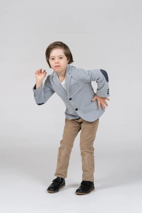 A young boy is posing for a picture