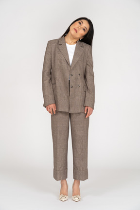 Front view of a young lady in brown business suit tilting head