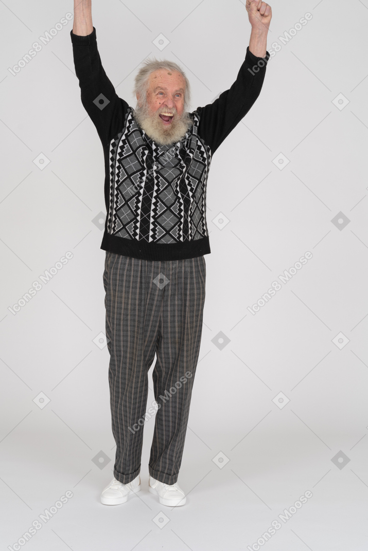 Front view of joyous old man raising his arms