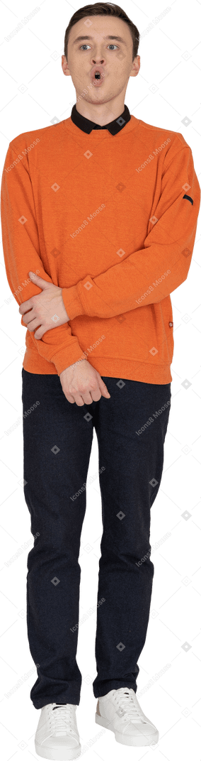 Young man in orange sweatshirt standing