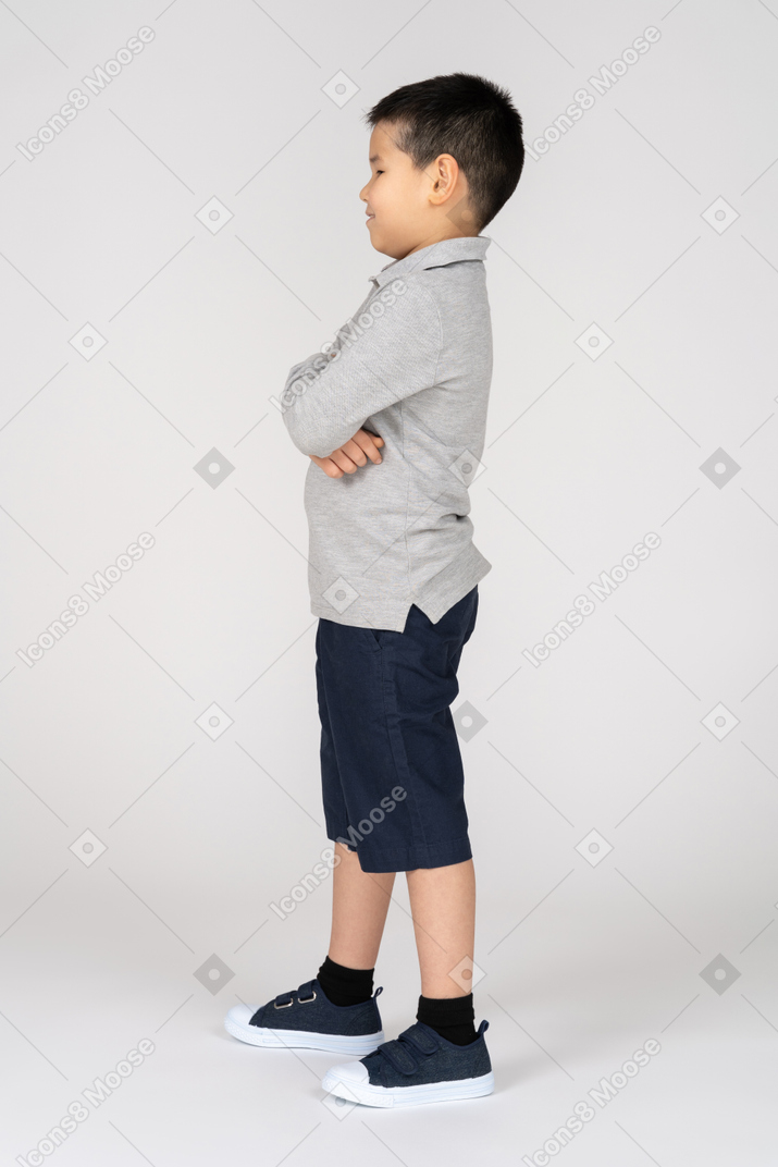 Boy standing with crossed arms