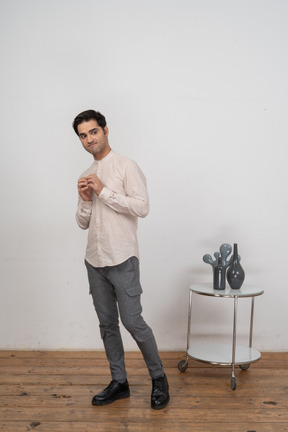 Confident man in shirt standing in front of camera