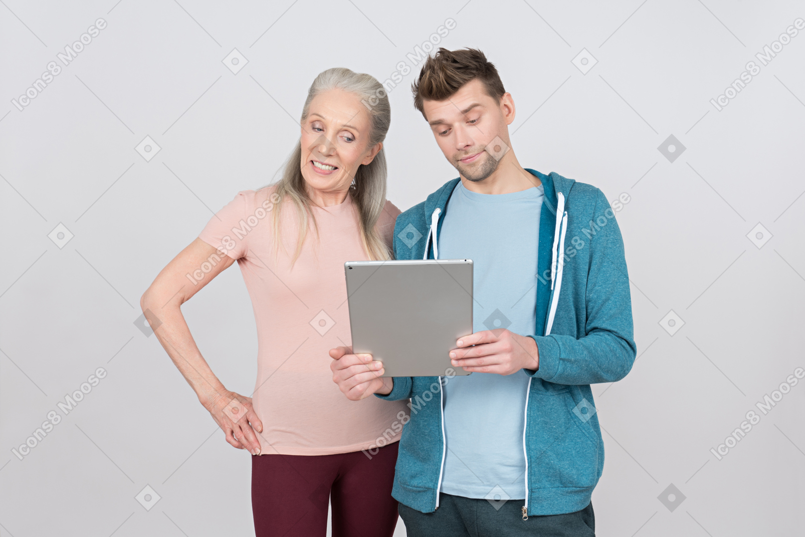 Old woman and young guy looking on digital tablet