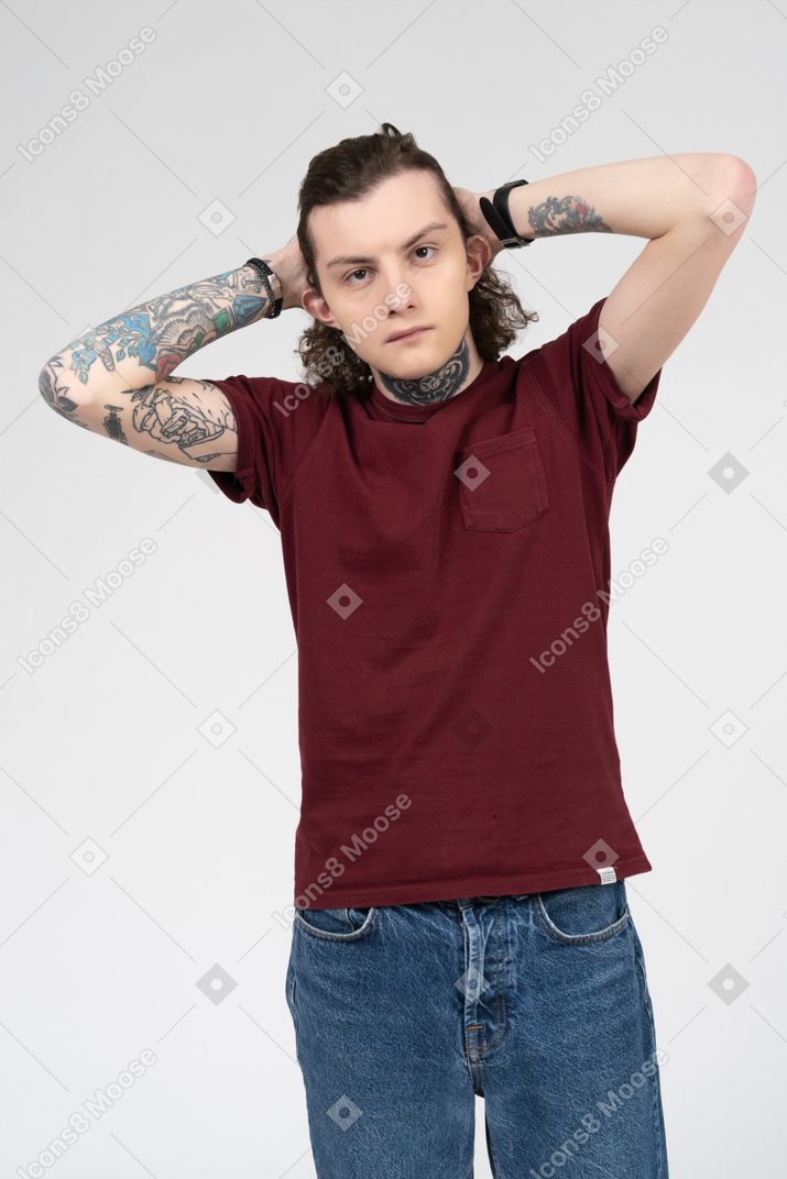 Portrait of a caucasian teenager holding hands behind the head