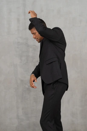 Man in black suit posing