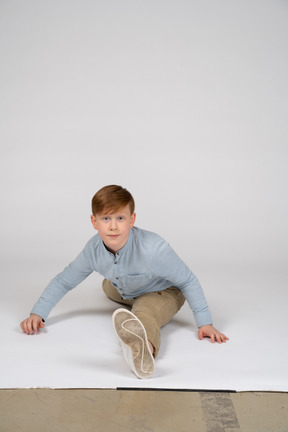 Front view of a boy doing a split
