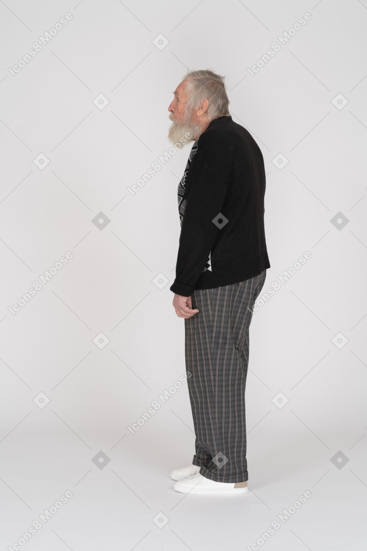 Side view of an old man in jumper standing