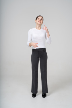 Front view of a happy woman in suit gesturing