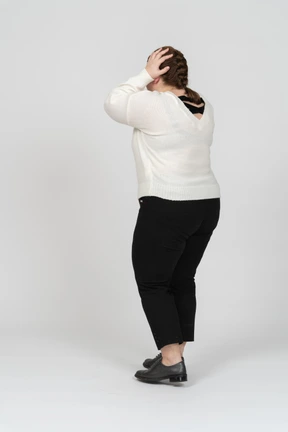 Scared plump woman in casual clothes