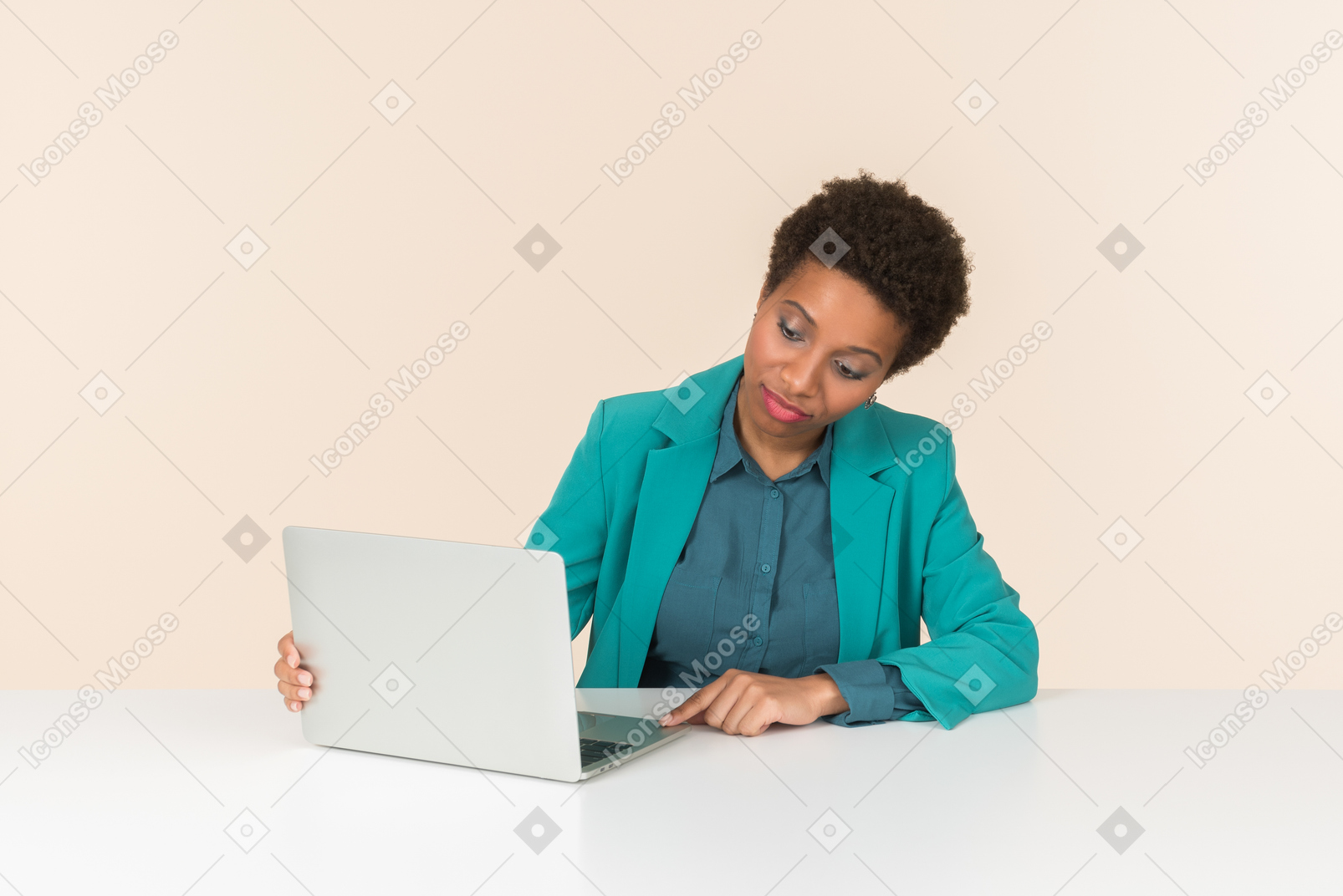 Female office worker sitting at the desk and checking laptop