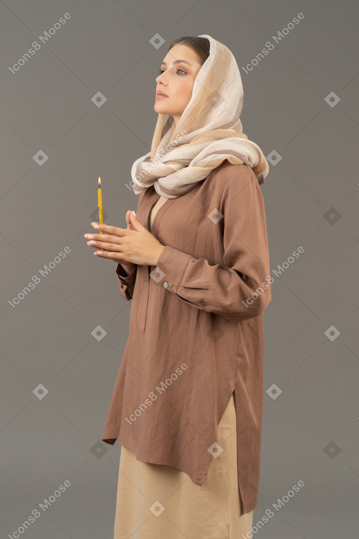 Religious woman holding a candle