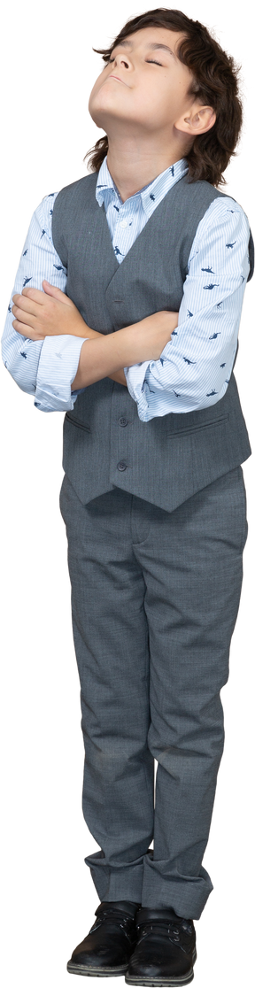 Front view of a boy in suit posing with crossed arms