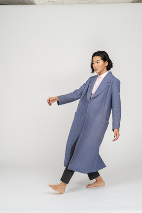 Woman in coat leaning backwards