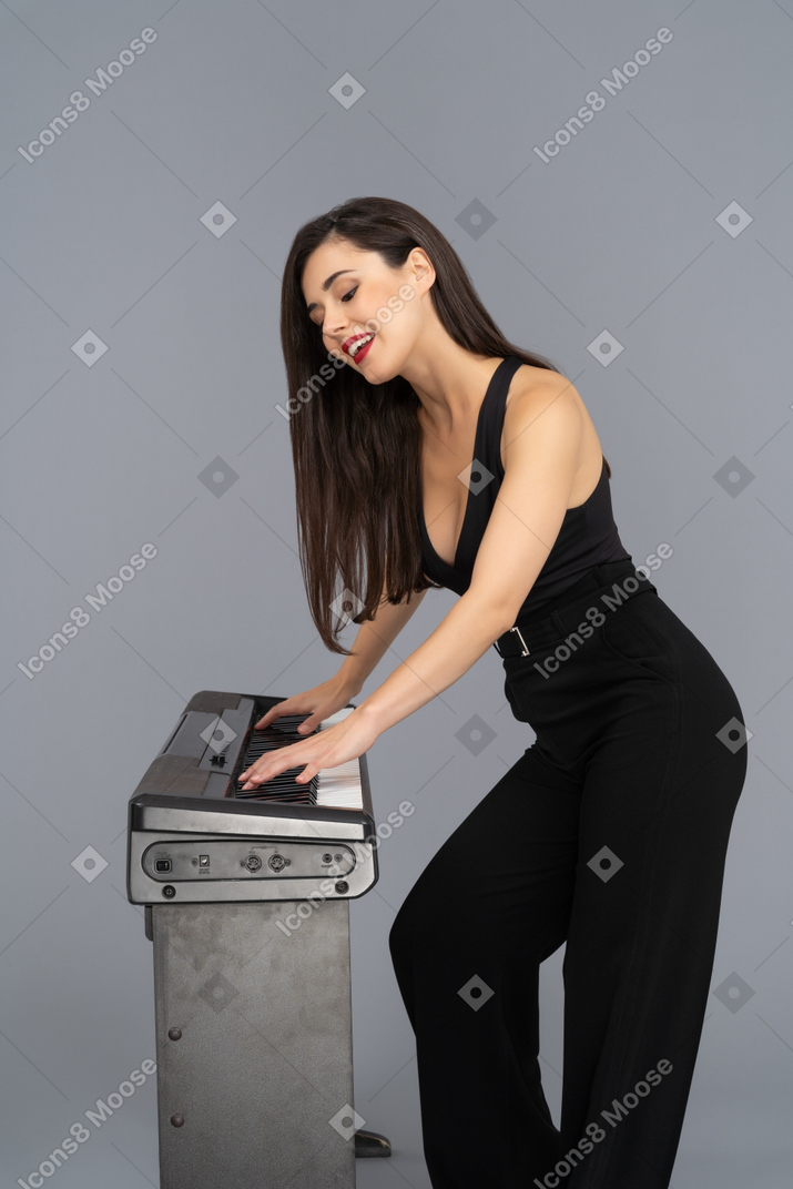 Cheerful young woman enjoying piano music