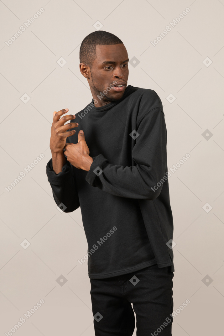 Man holding imaginary object and turned away