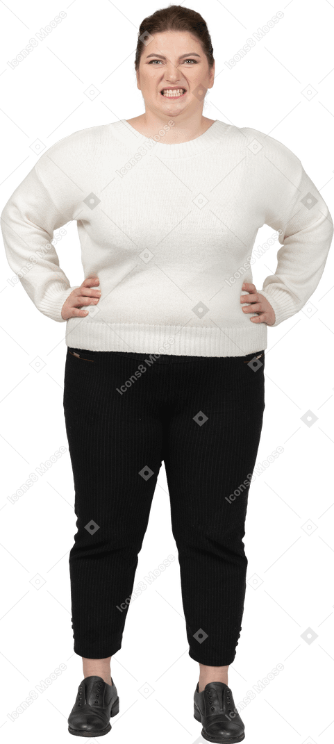 Angry plump woman in casual clothes looking at camera