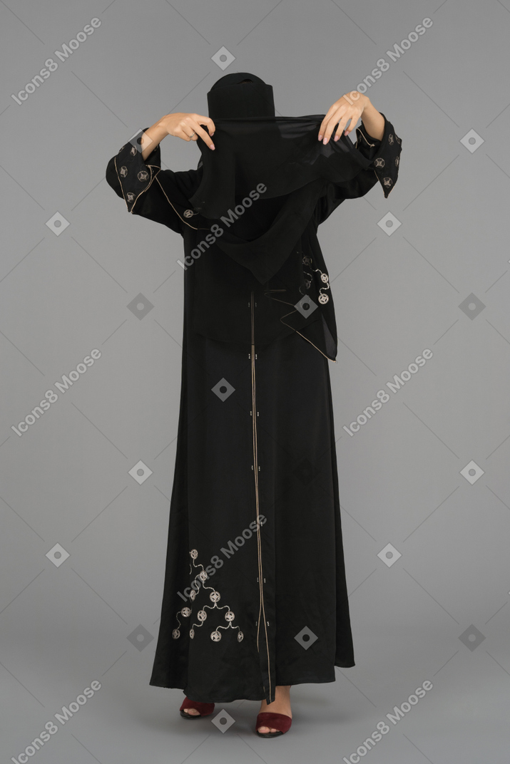 A musim woman arranging her niqab