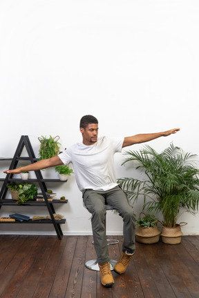 Good looking young man posing on the background of the apartment