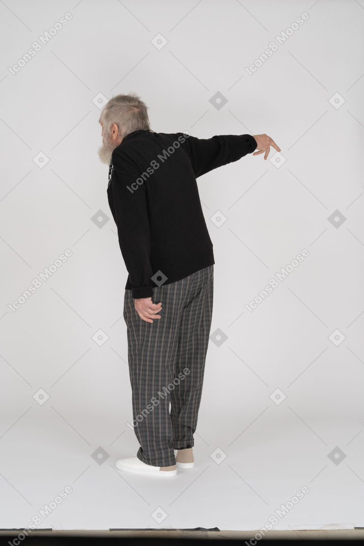 Back view of old man complaining and pointing away