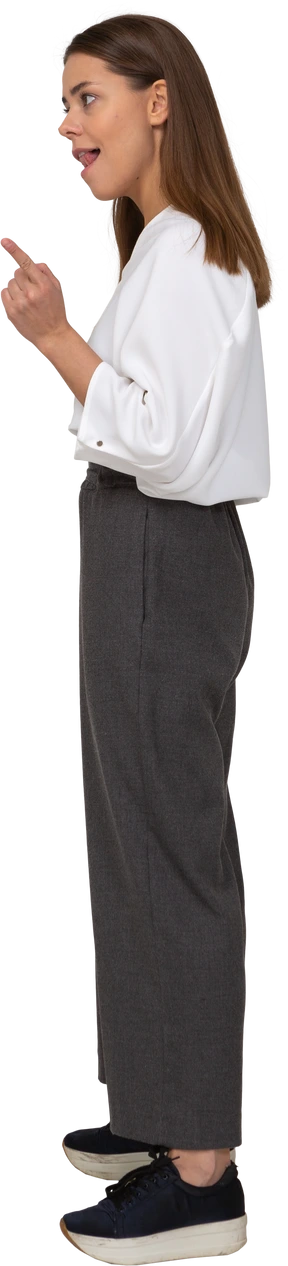 Side view of a warning young lady in office clothing raising finger