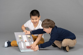 Children having fun with illustrated book