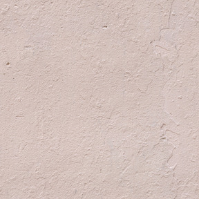 淡いピンクの漆喰壁のテクスチャ