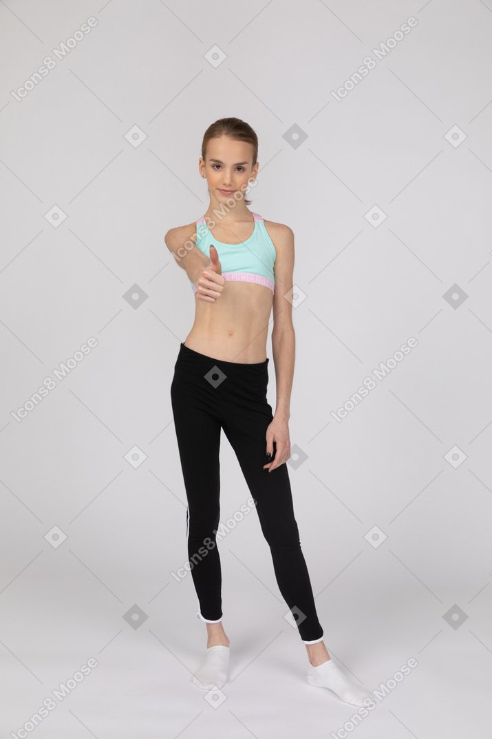 Sporty girl showing thumb up