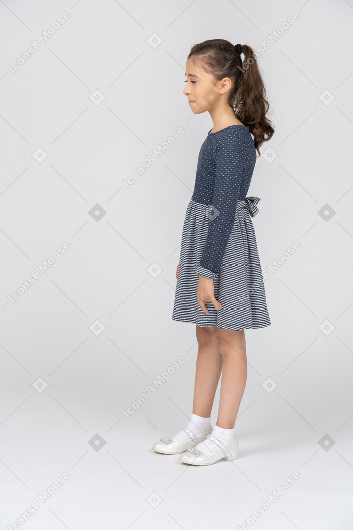 Side view of a girl suppressing a smile