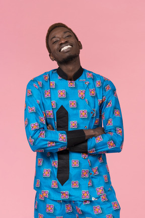 Black man in blue pajamas smiling