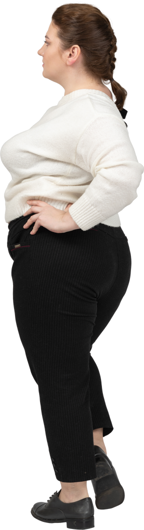 Plus size woman in casual clothes posing with hands on hips