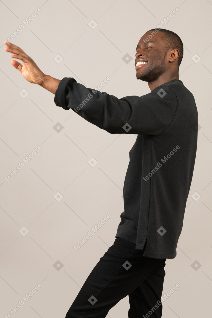 Black man with eyes closed outstretching hand