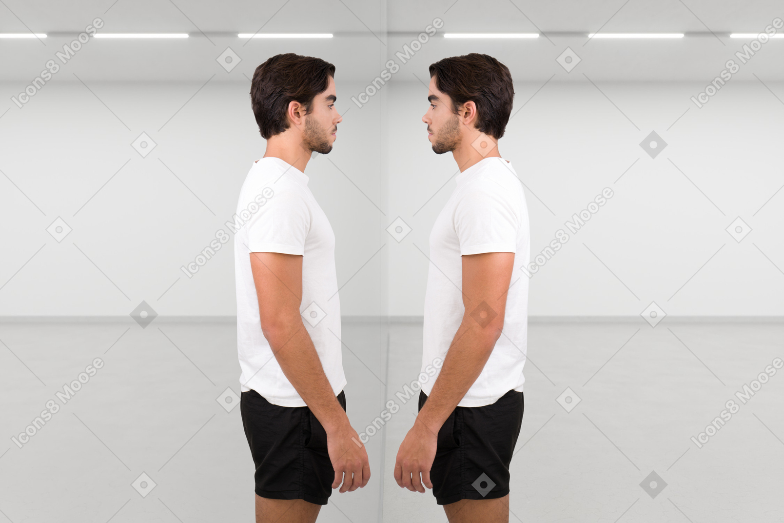 A pensive young man standing in front of his reflection