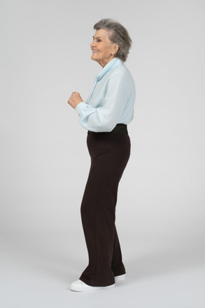 Side view of an old woman looking excited