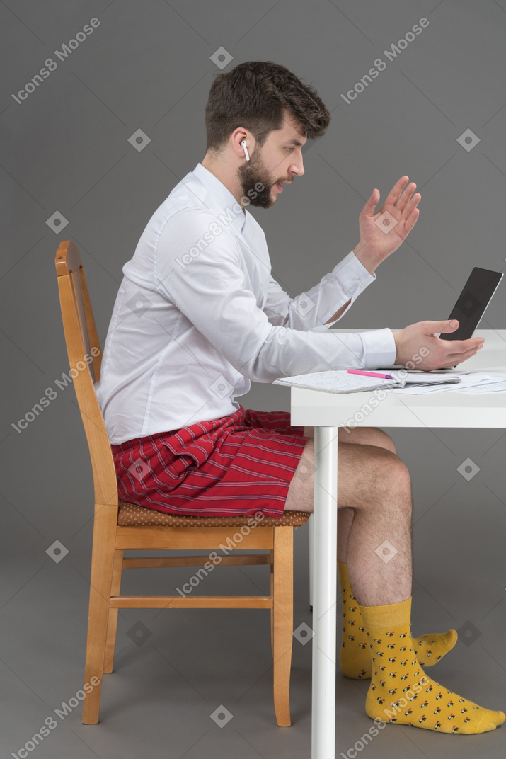 Businessman holding online meeting during pandemic