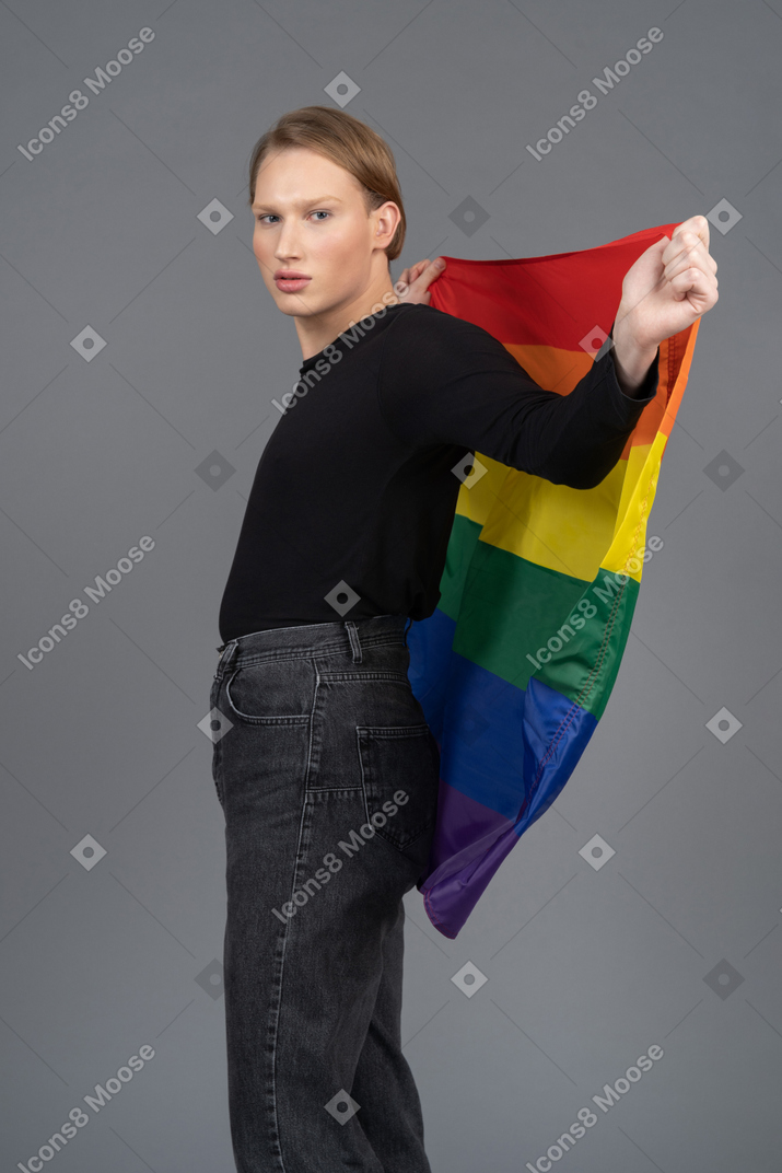Person holding a rainbow flag